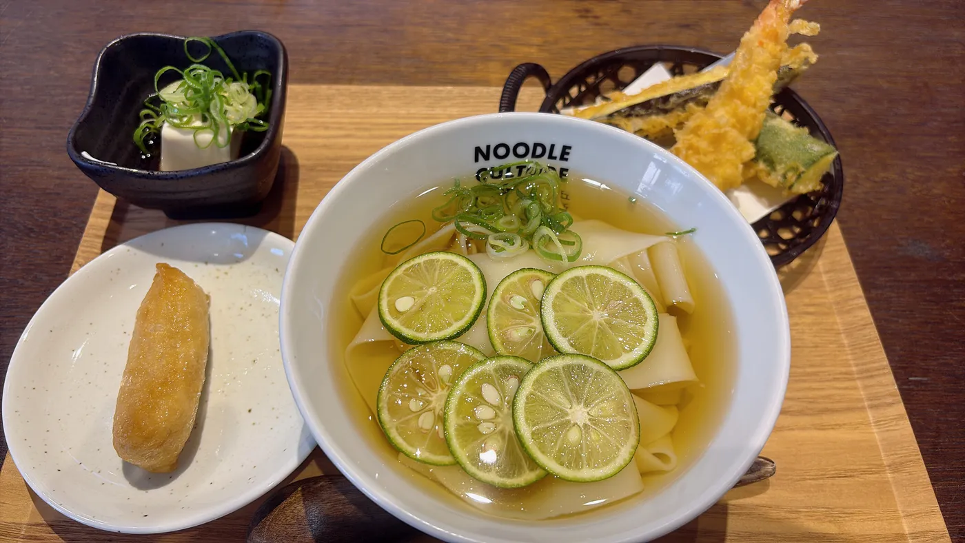 星が丘製麺所の天太門セット。すだちがのったきしめん、天ぷら盛り合わせ、薬味豆腐、揚げ物が並ぶ