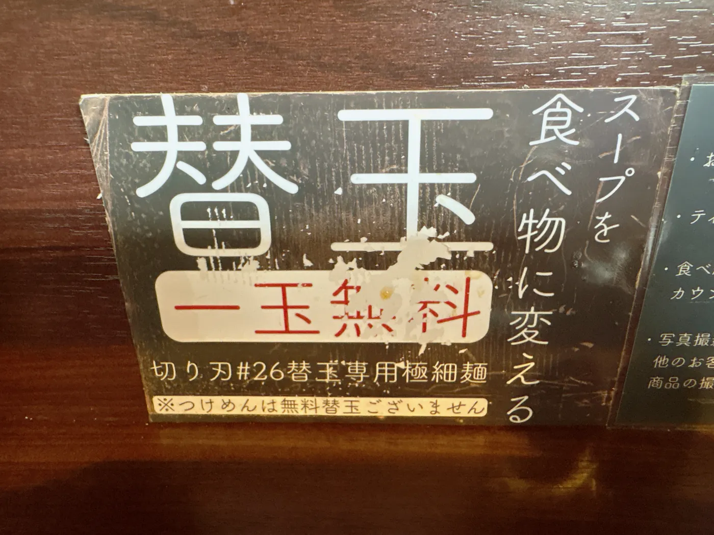 麺乃はるの替玉案内。スープを食べ物に変える一玉無料、つけめんは無料替玉なしと書かれている