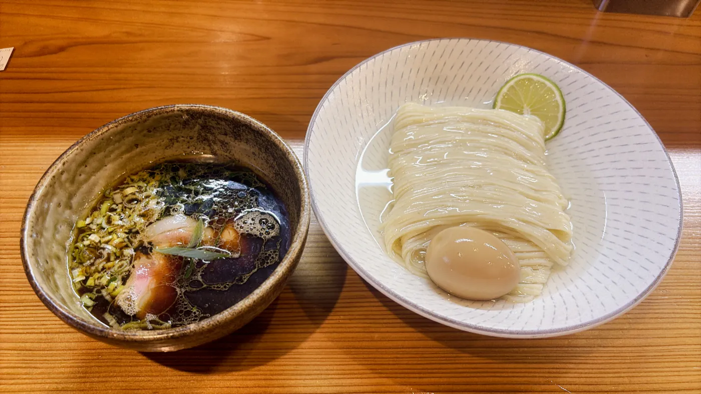 つけそば神宮寺の鰹昆布出汁醤油つけそば。左につけダレ、右に麺と味玉、すだちがのった二椀構成